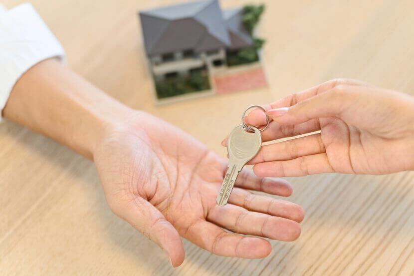 Hand of a woman handing over the house key