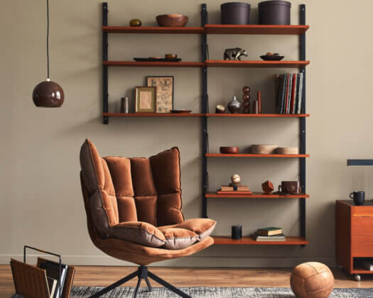 Stylish interior of living room with design brown armchair, wood