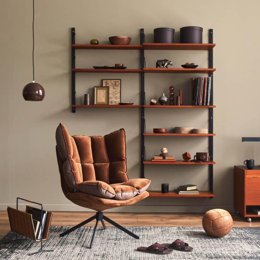 Stylish interior of living room with design brown armchair, wood