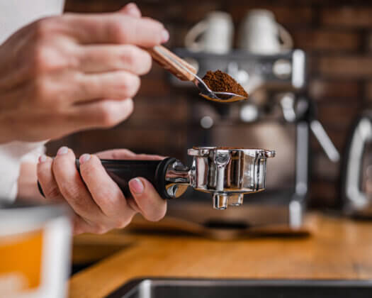 Woman Is Pouring Coffee Into Espresso Machine Portafilter