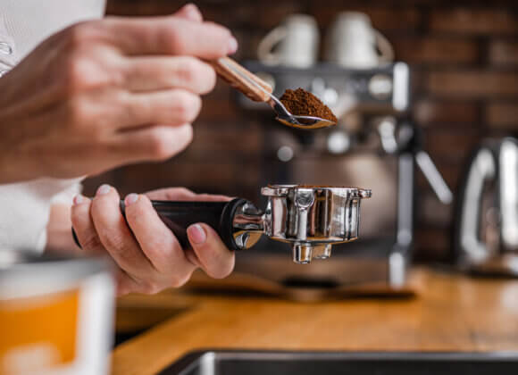 Woman Is Pouring Coffee Into Espresso Machine Portafilter